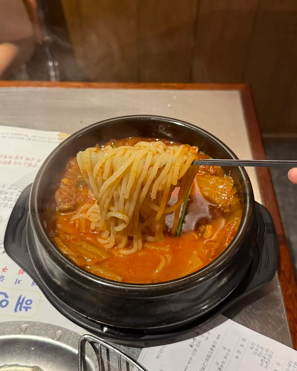 Pork kimchi stew with potato noodles added