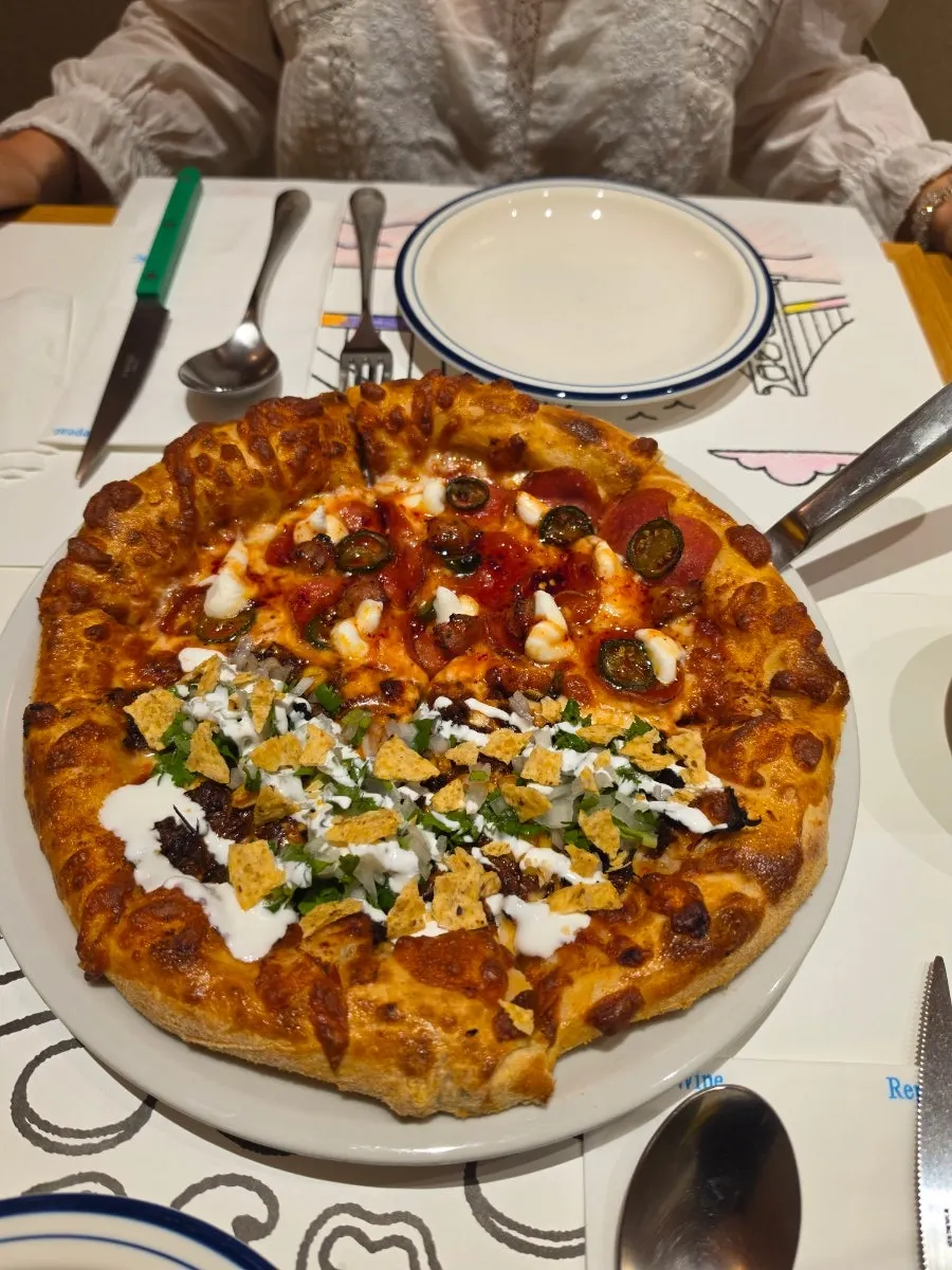 Table set with pizza and pickles