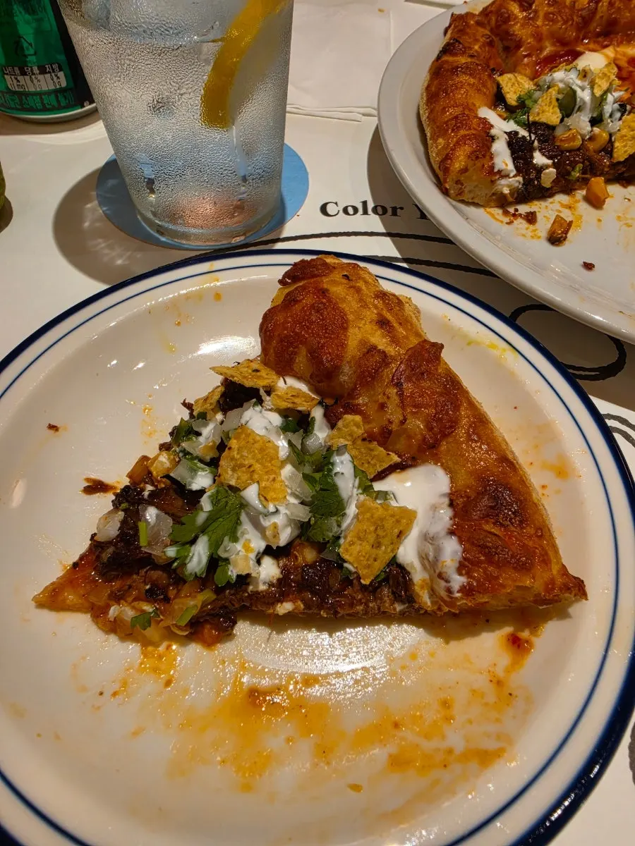 Romesco grilled vegetables and pizza on a plate
