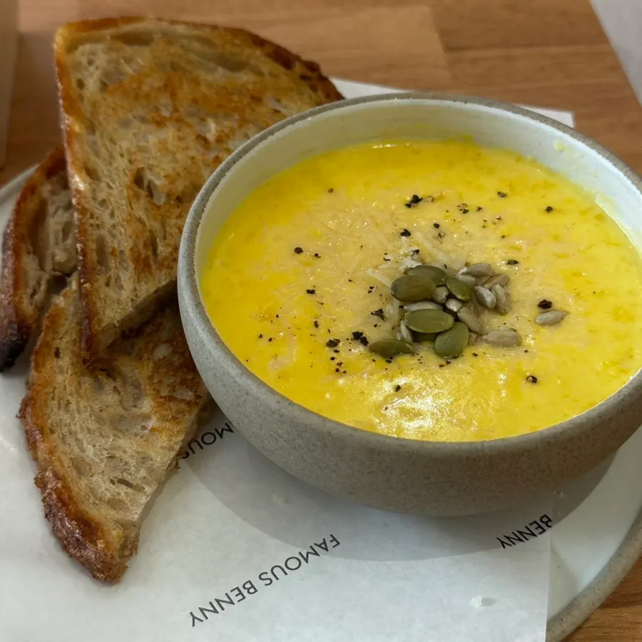 Pumpkin soup topped generously with pumpkin seeds