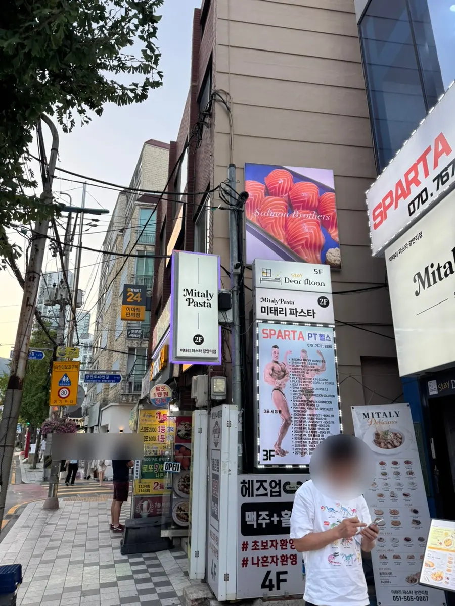 Salmon Brothers 2nd-floor storefront with a photo of giant salmon sushi