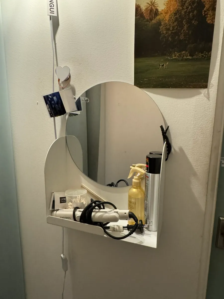 Curling iron and hairspray set out near the restroom