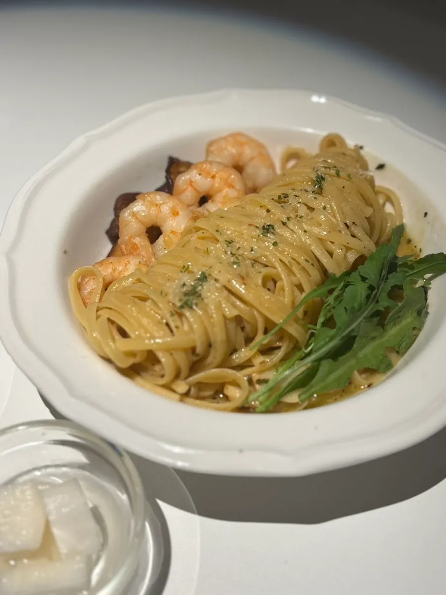 Aglio e olio topped with plump shrimp
