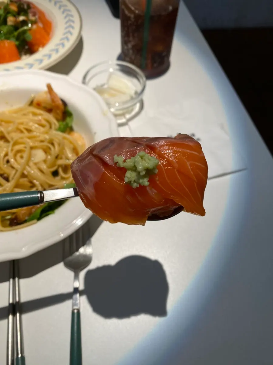 A plate of thick-cut raw salmon sushi