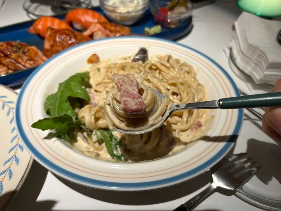 Truffle cream pasta topped with mushrooms and bacon