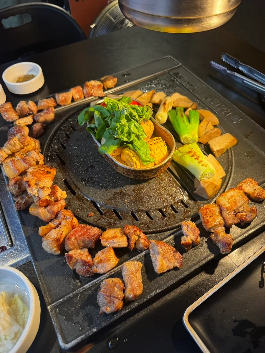 Staff member grilling pre-seared meat