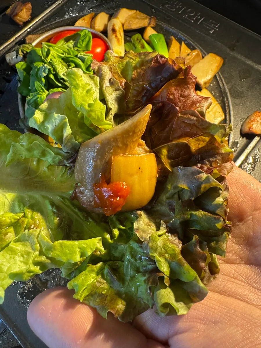 A slice of pork belly dipped in anchovy salt
