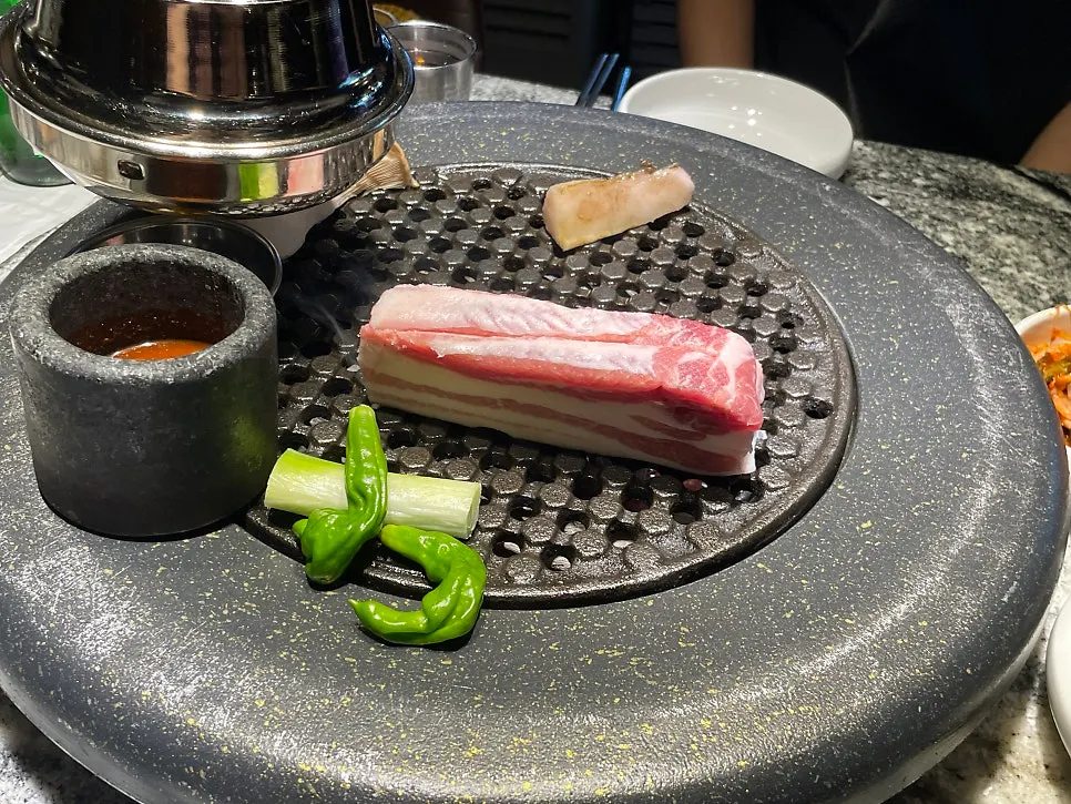 Plate of pork belly, pork neck, mushrooms, green onion and gwarigochu