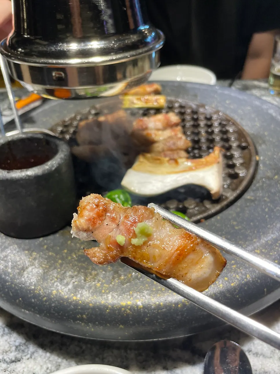 A piece of pork topped with wasabi