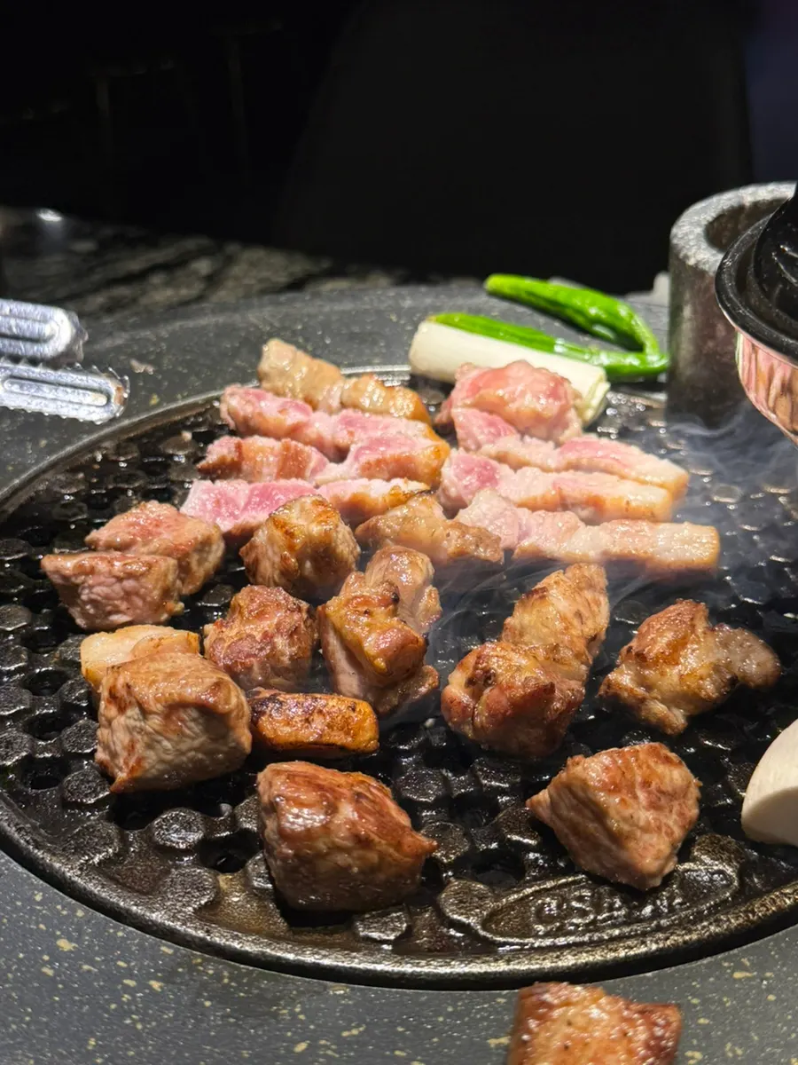Pork belly and mushrooms grilling over charcoal