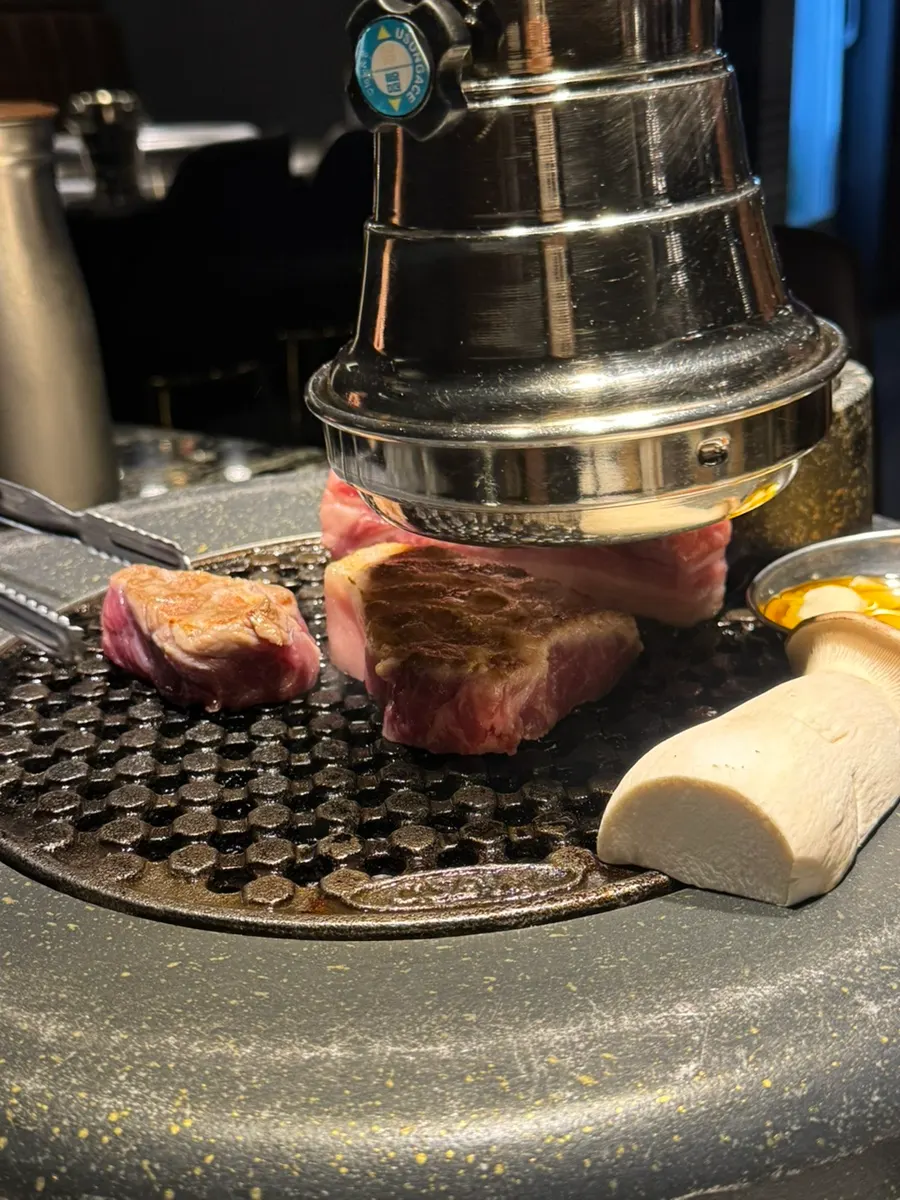 Pork belly turning golden brown over charcoal