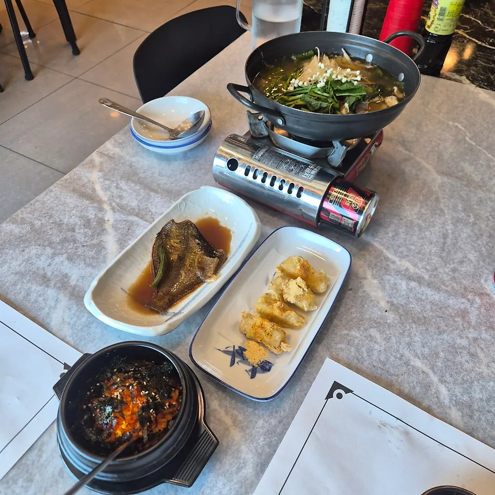 The final spread of spicy fish stew, egg rice and corn fritters