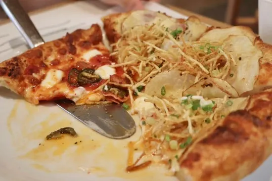 Slice of pizza made with 48-hour cold-fermented dough