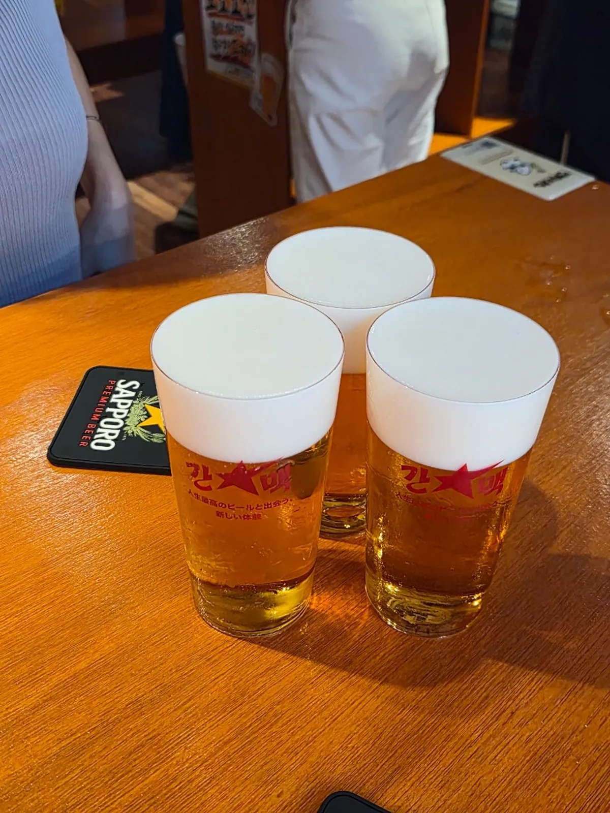 A glass of Sapporo draft beer with rich foam