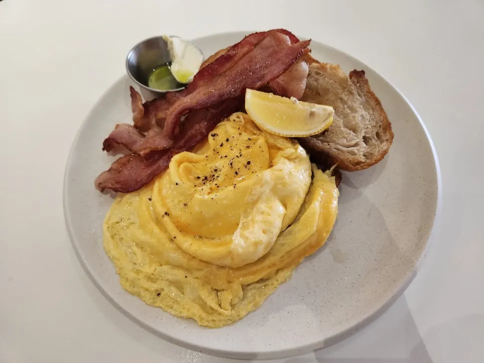 A brunch table with a baby seated nearby