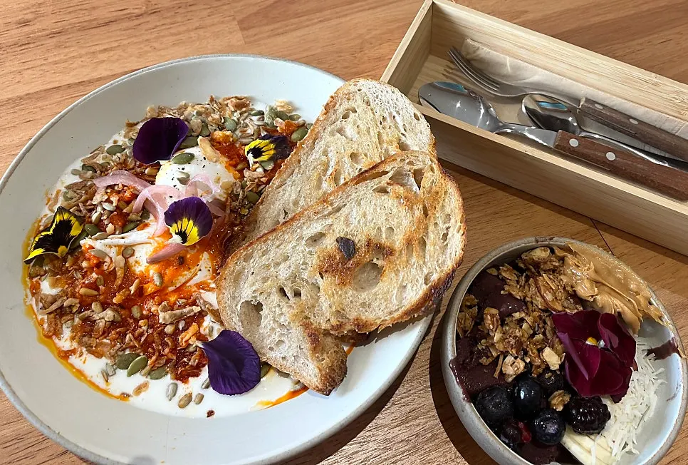 Table with Acai Bowl and Garlic Butter Eggs side by side
