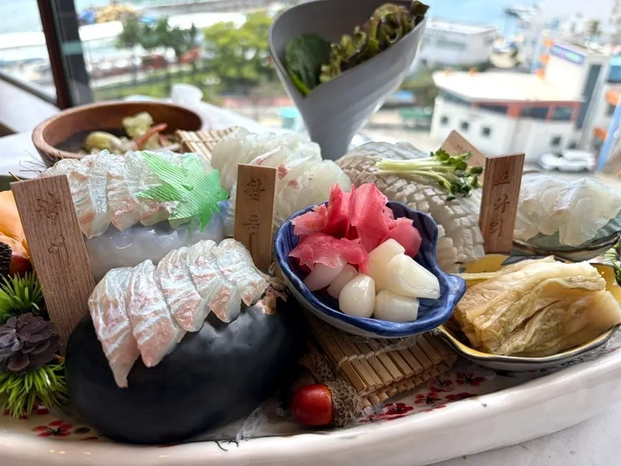 Table filled with food before the sashimi arrived