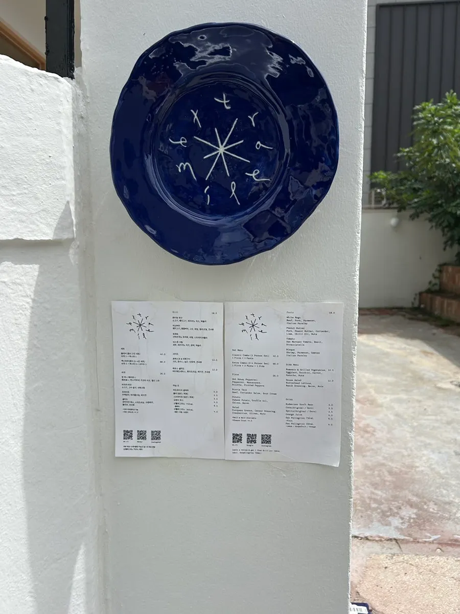 Menu board posted outside Extra Mile