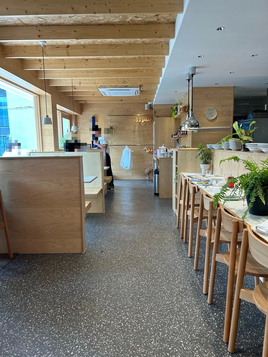 View of the wood-toned dining hall from further inside