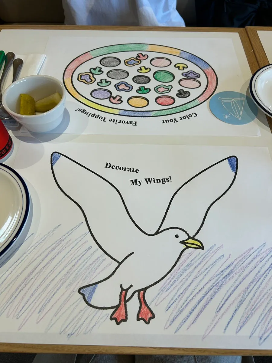 Coloring placemat and crayons on the table