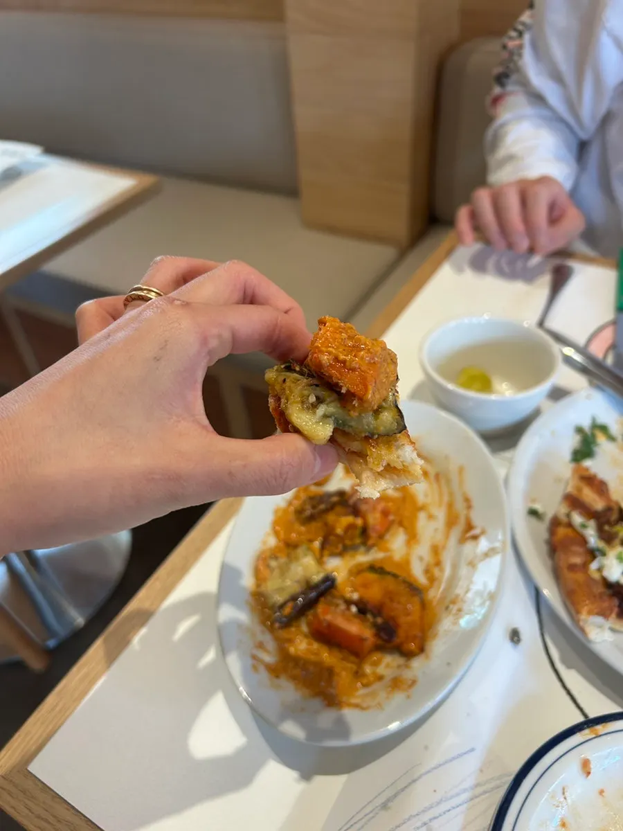 Pizza crust topped with romesco grilled vegetables