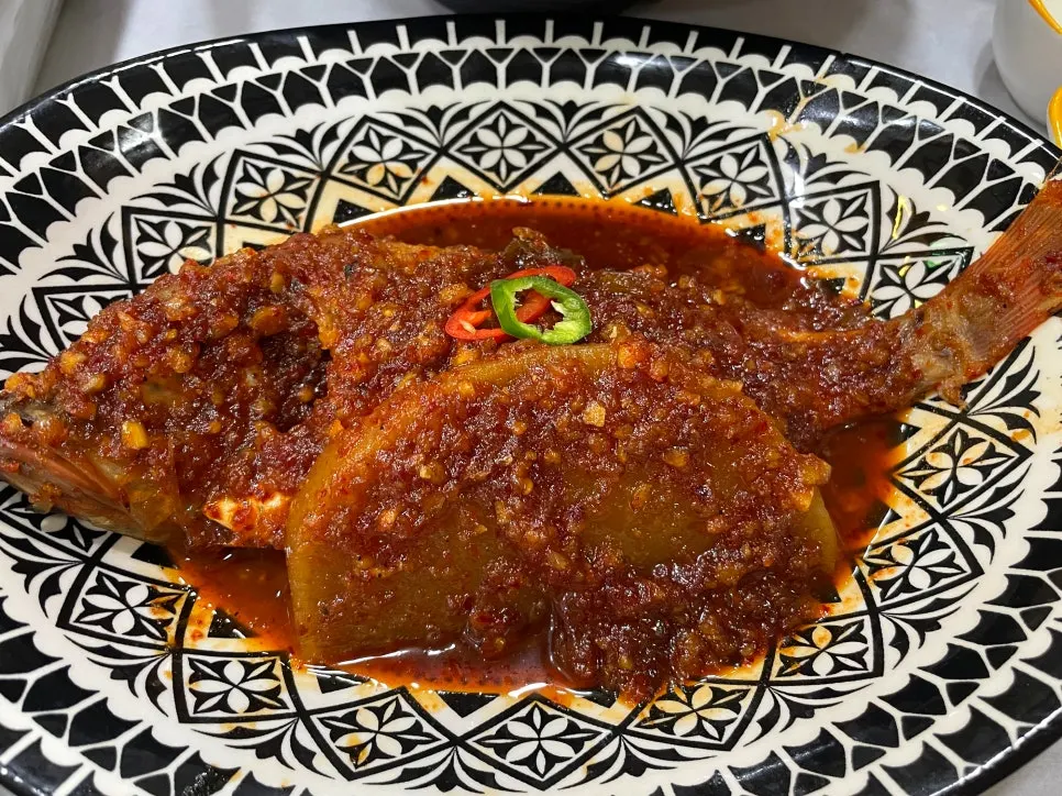 A bowl of braised fish with tender flesh