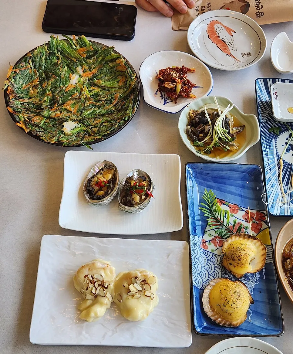 Butter-grilled scallops, soy-marinated crab, and ginseng root