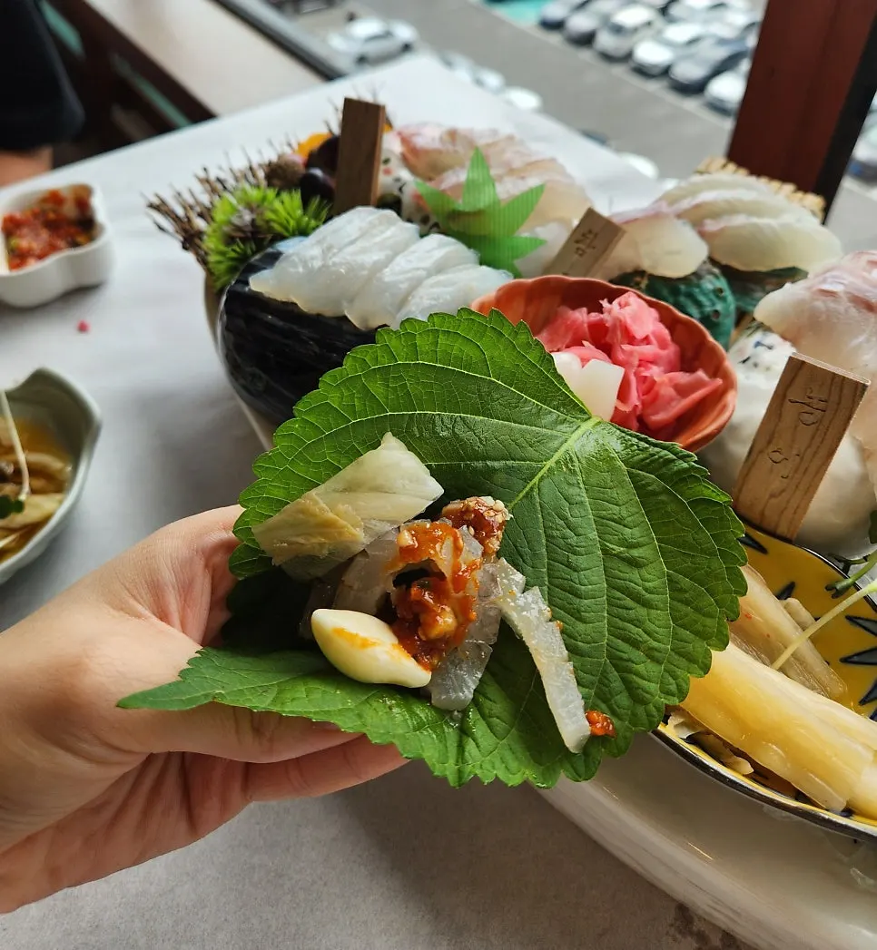 A piece of chewy red seabream and flatfish sashimi