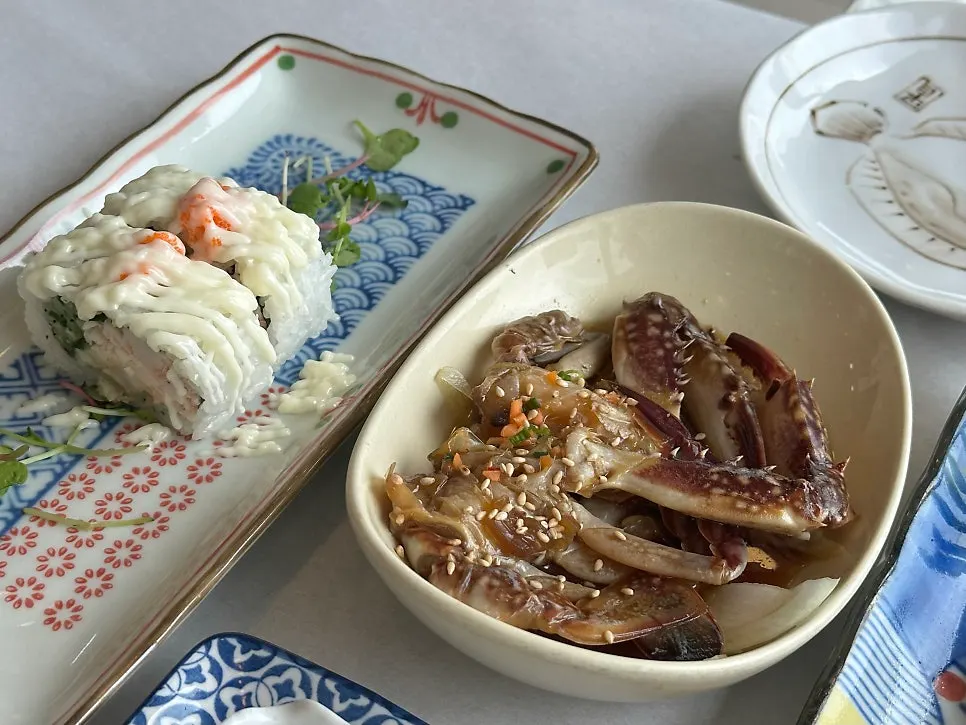 Sseukidashi spread including sashimi salad and pufferfish skin salad