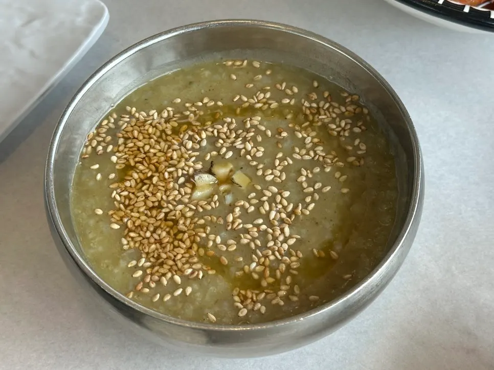 Warm abalone porridge topped with sesame seeds