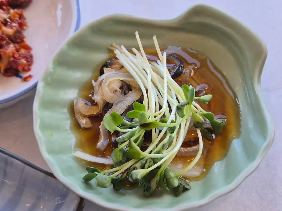 Second round of dishes with pufferfish skin salad and steamed abalone