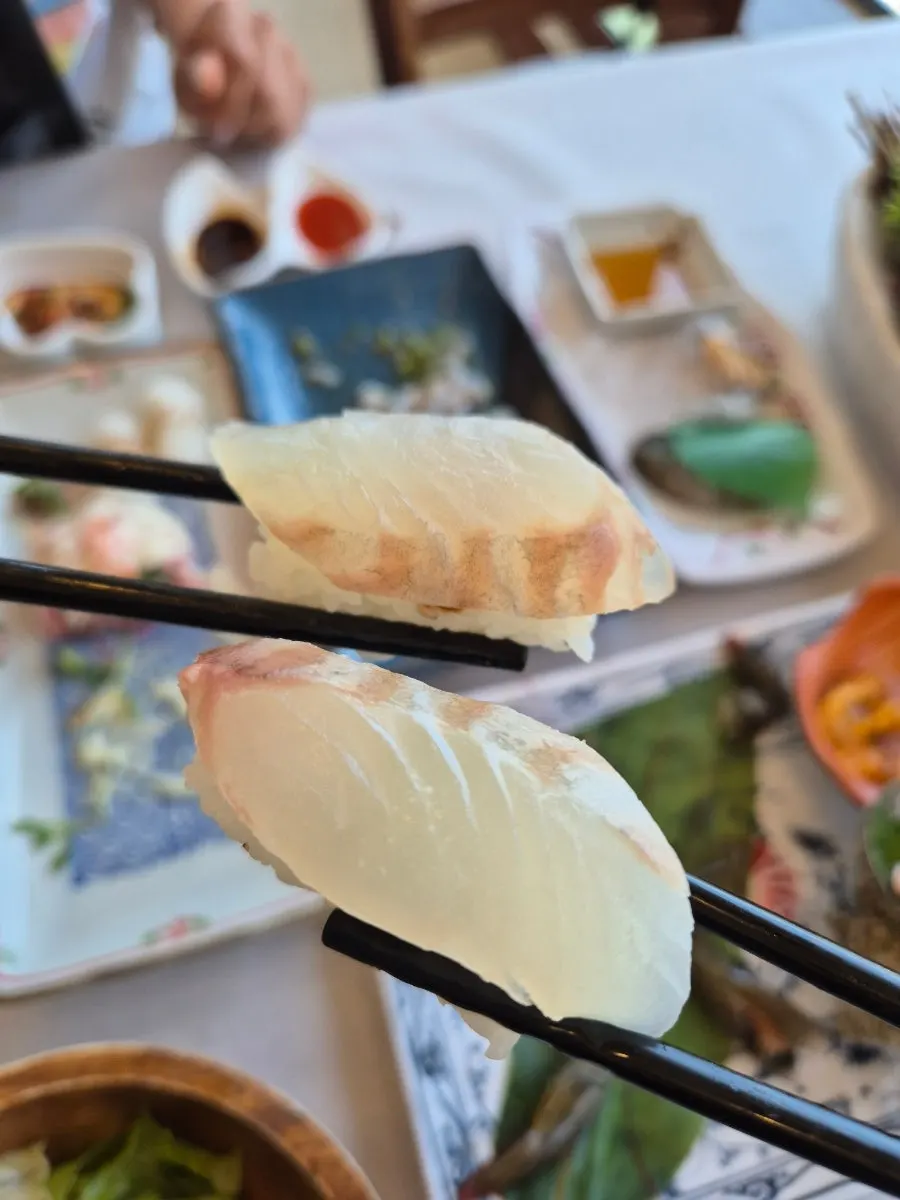 A piece of sashimi prepared to wrap in lettuce