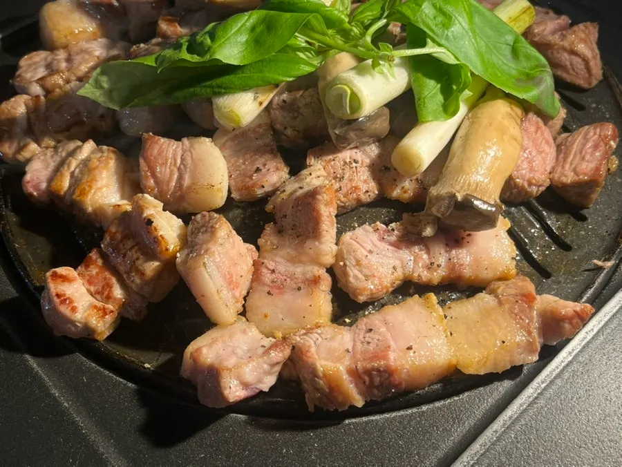 Mushrooms and basil cooking together on the pan