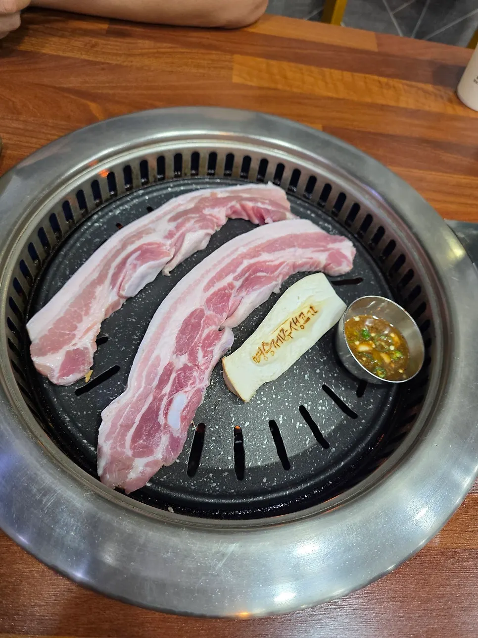 Pork belly on the grill at Myeongseung Jeju Saenggogi