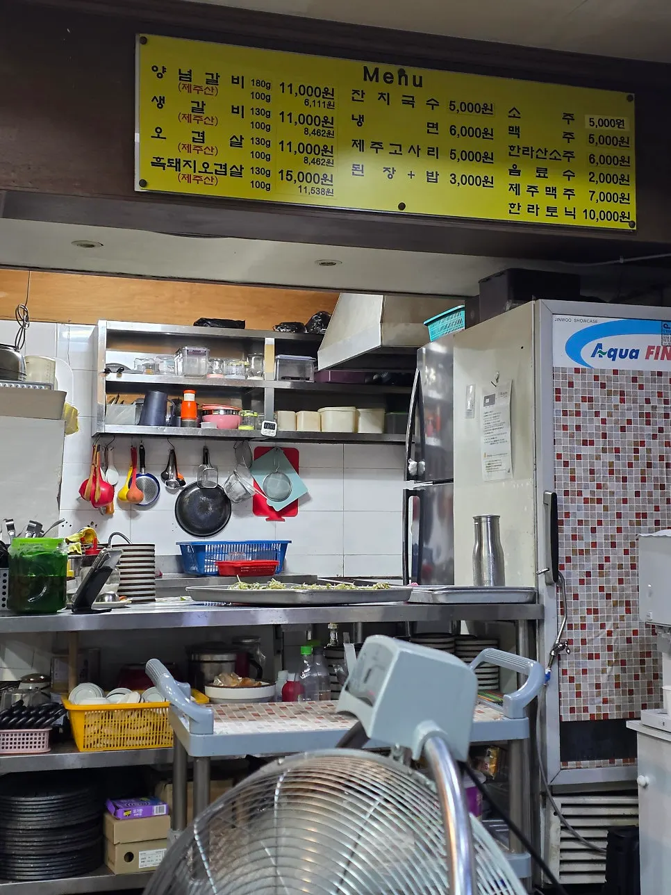 Menu board on the wall at Myeongseung Jeju Saenggogi