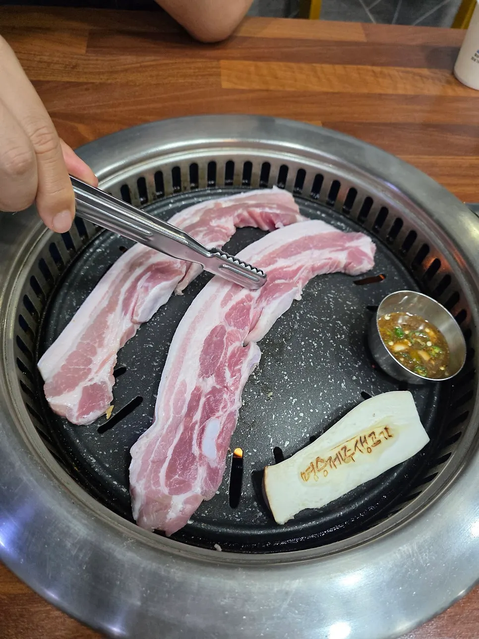 Pork belly placed on the grill to start cooking