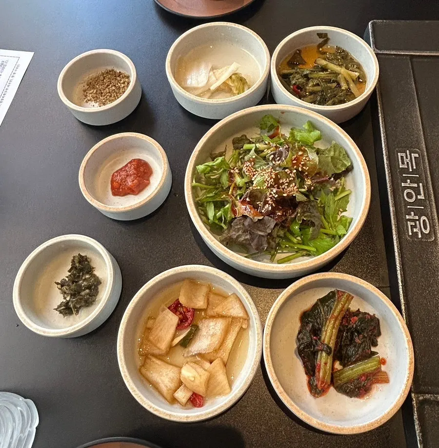Gwang-anmok banchan spread including mustard leaf kimchi and pickles