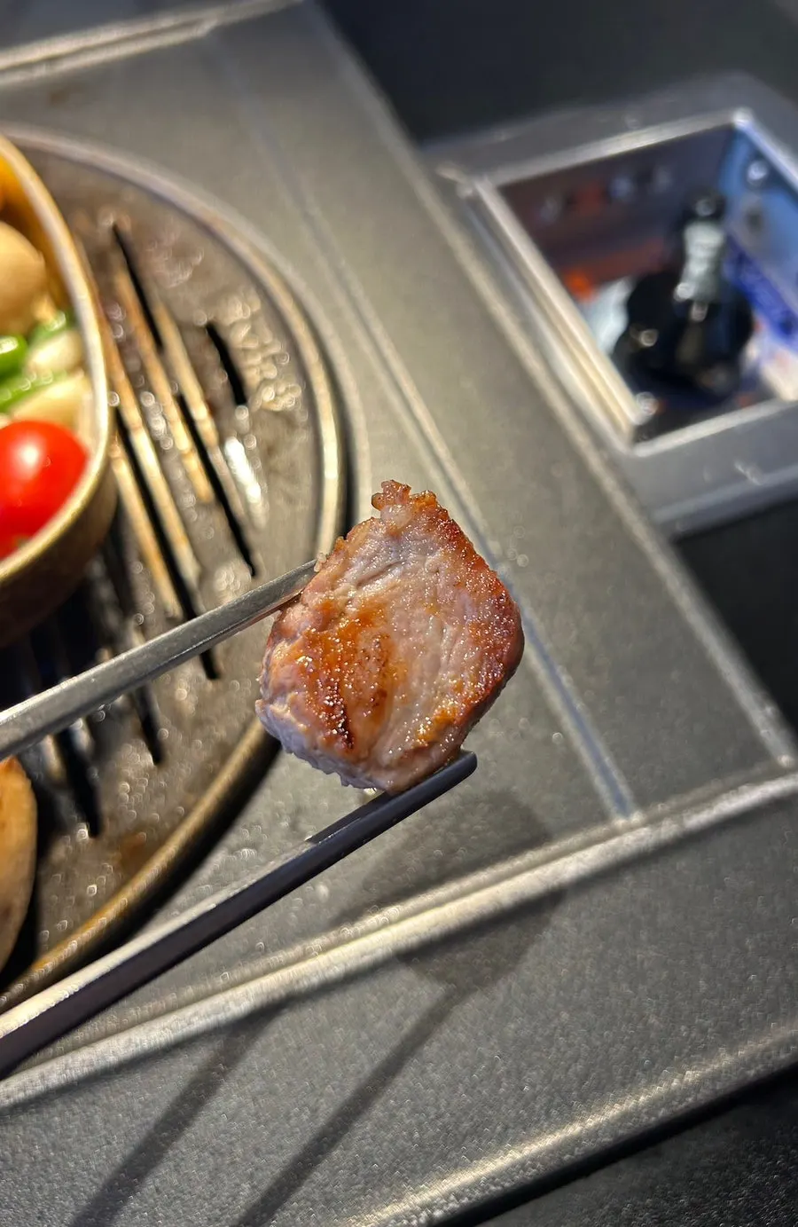 Aged pork neck just before dipping into sauce