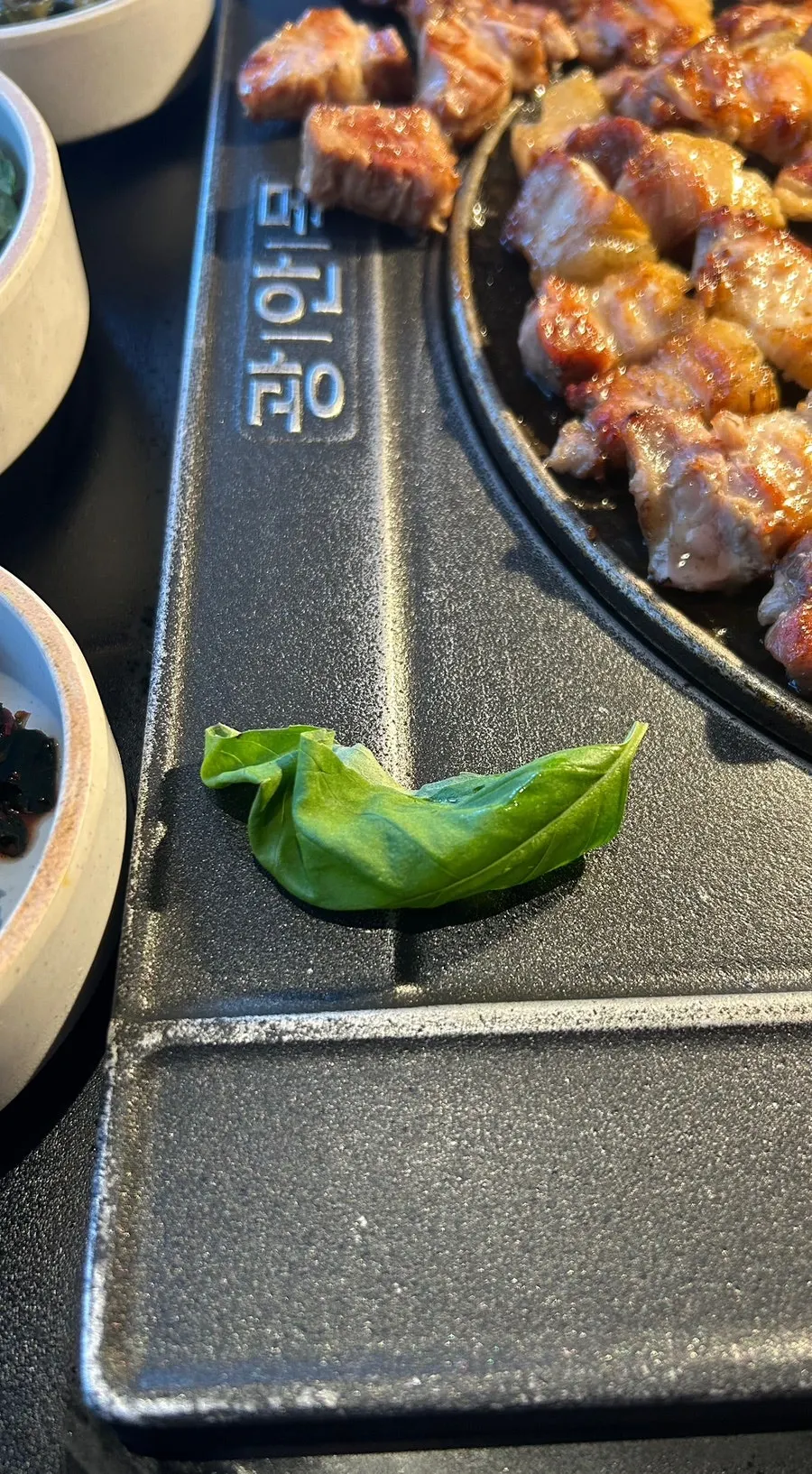 A piece of dry-aged meat placed on basil