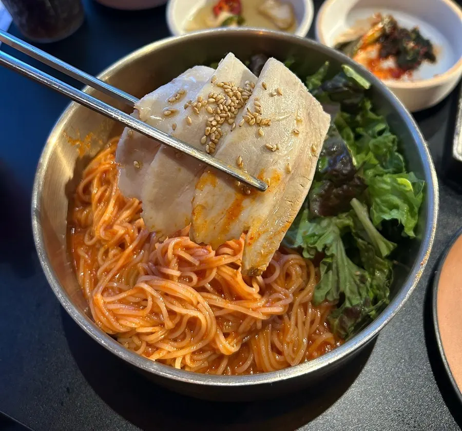 Cold pork bibim noodles mixed with lettuce