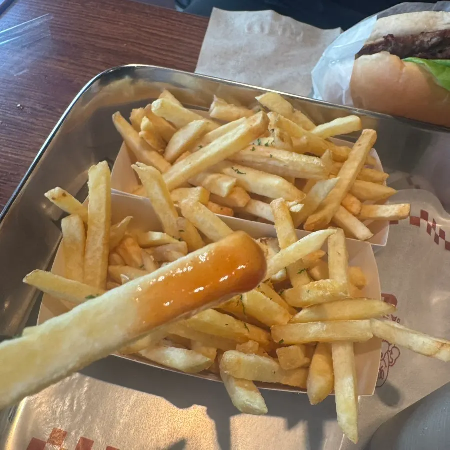 Holding and eating the burger