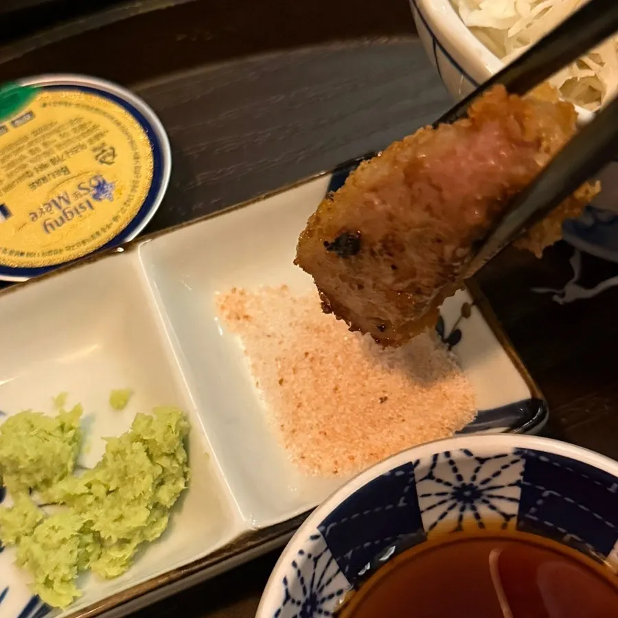 A piece of gyukatsu topped with wasabi