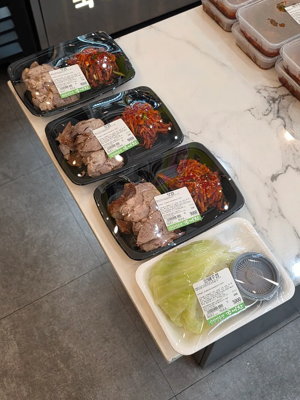 Main side dishes on display, including bossam and jeyuk bokkeum