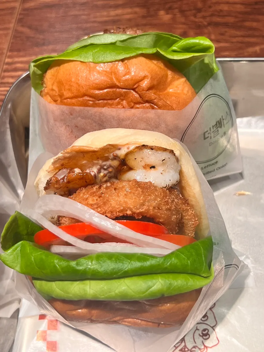 Cross-section bite of the Double Base Burger with vegetables