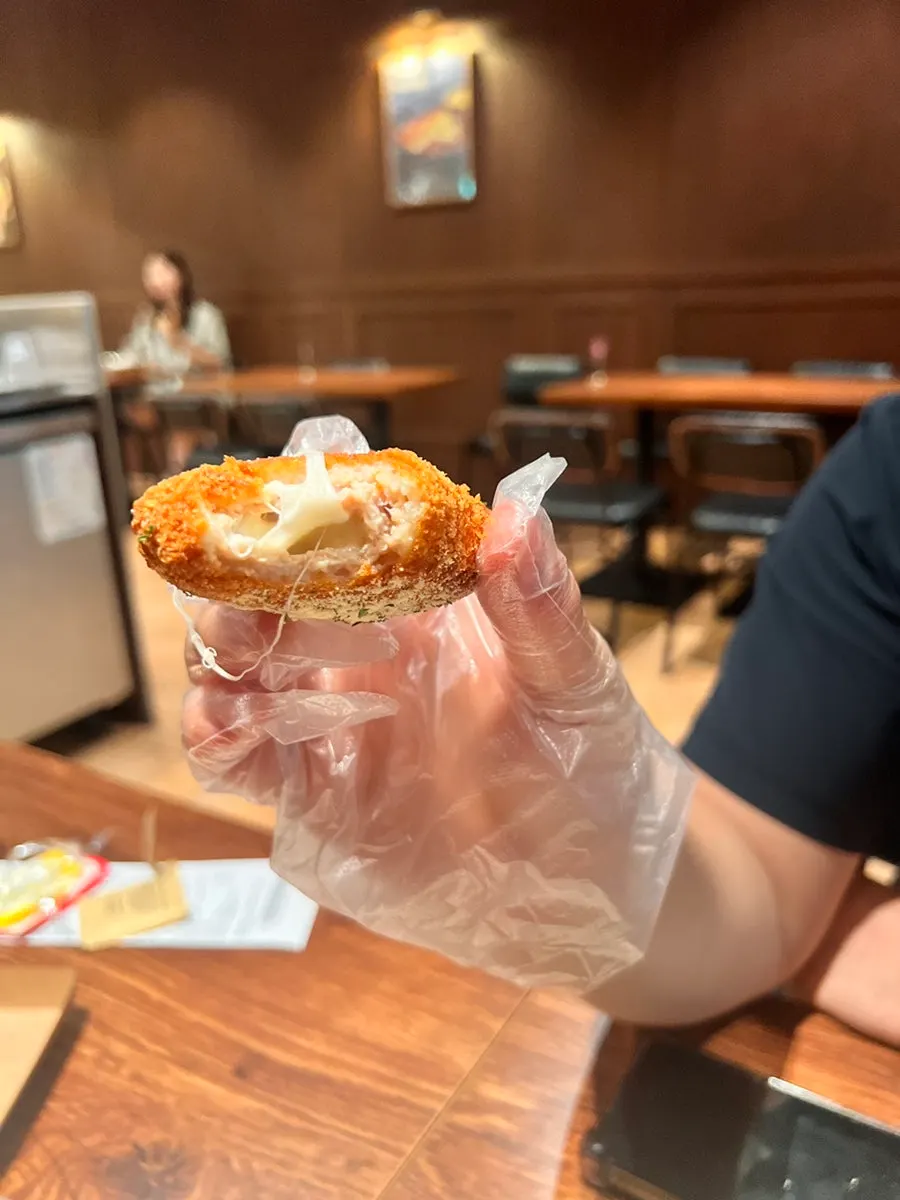 Cross-section of the shrimp burger showing whole shrimp and onion rings