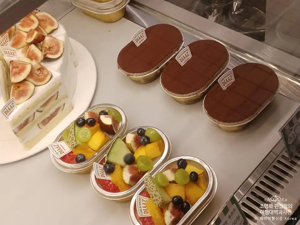 Mango slice cake visible in the showcase