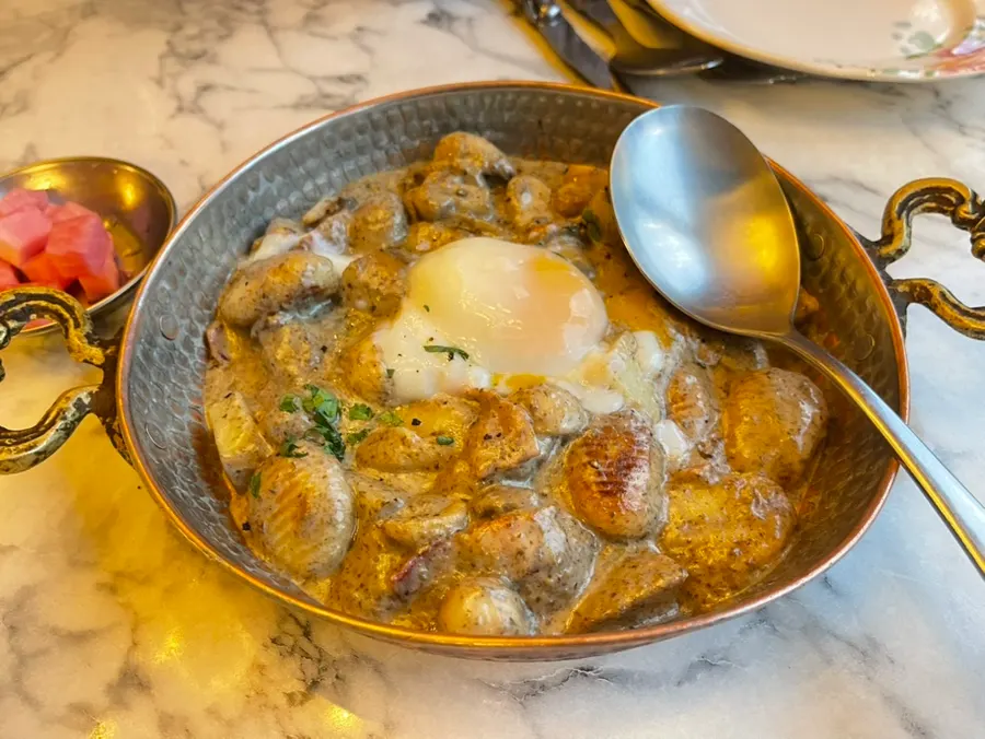 Truffle cream homemade gnocchi topped with a poached egg