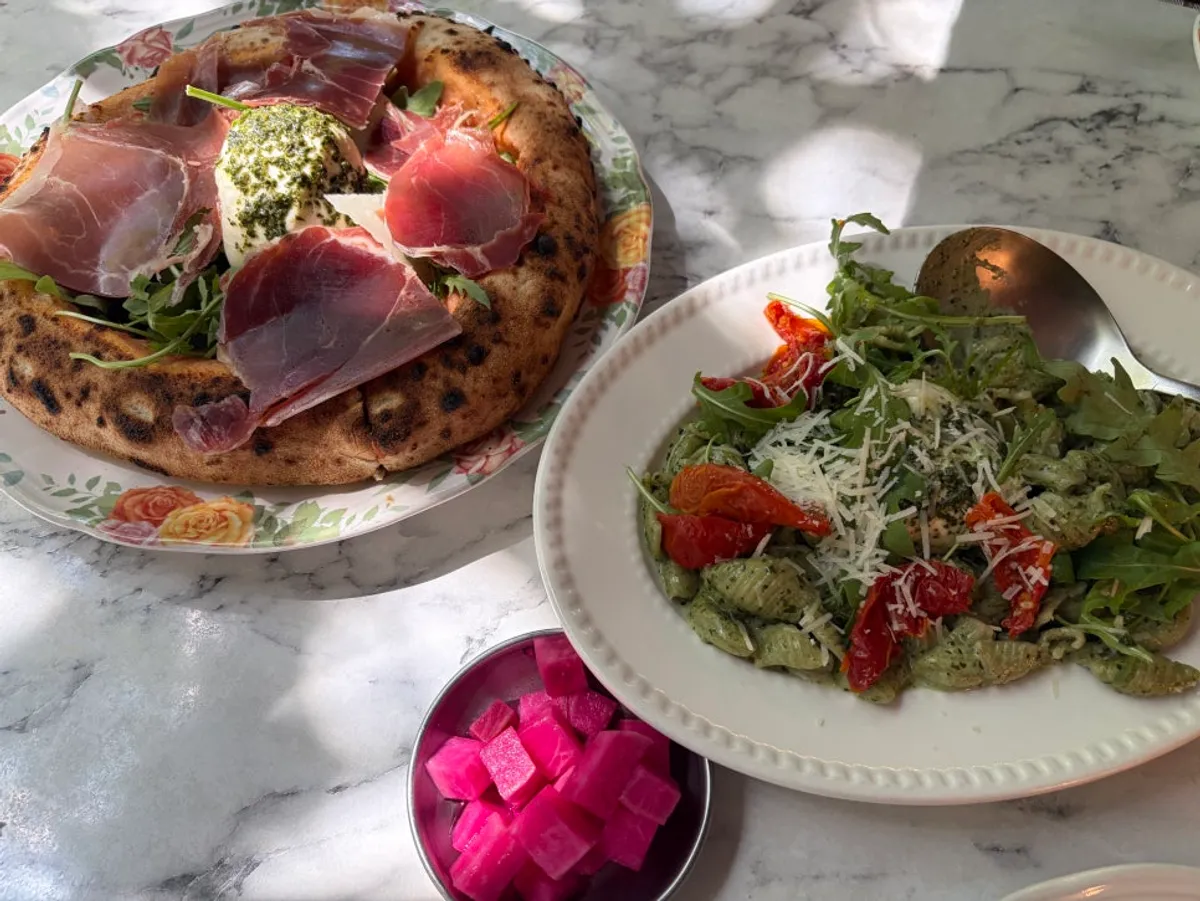 Wood-fired pizza and pasta served at the table