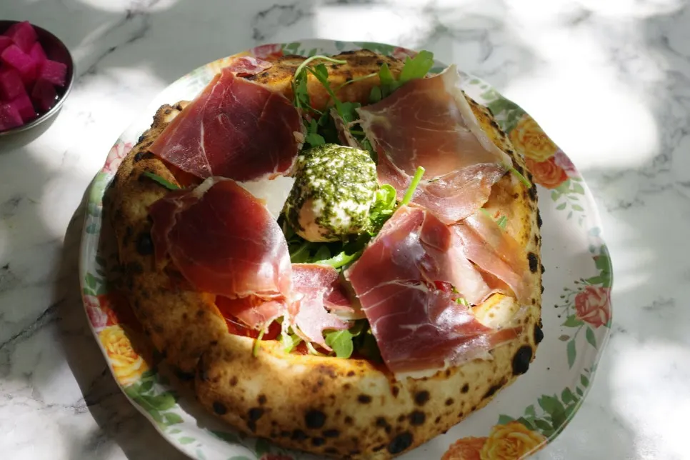 Rocket ham burrata pizza fresh out of the oven