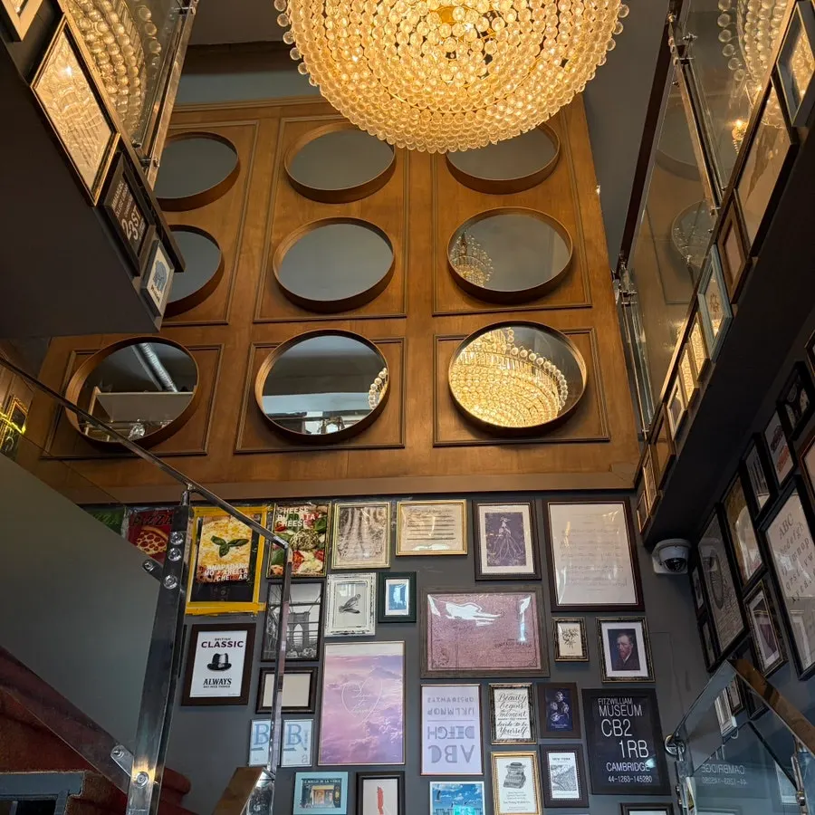 Restaurant staircase decorated with frames and mirrors